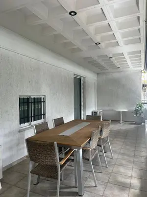 a conference room with a wooden table and chairs at anastasis house in Athens