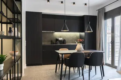 a kitchen and dining room with a table and chairs at Academy Elegant Apartment #102 in Athens