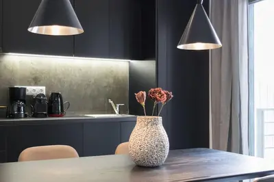 a vase with flowers on a table in a kitchen at Academy Elegant Apartment #102 in Athens