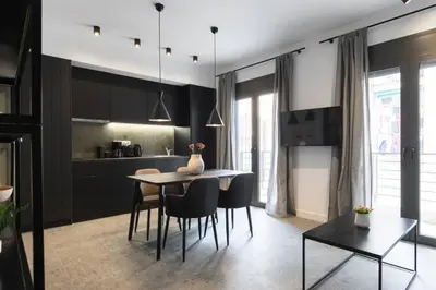 a kitchen and dining room with a table and chairs at Academy Elegant Apartment #102 in Athens