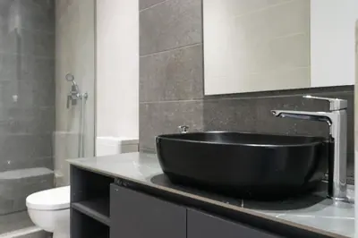 a bathroom with a black sink and a toilet at Academy Elegant Apartment #102 in Athens
