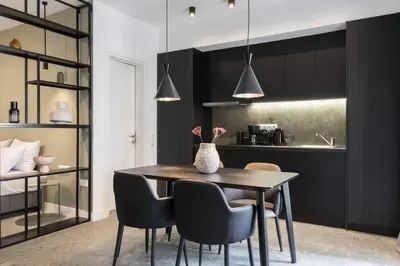a kitchen and dining room with a table and chairs at Academy Elegant Apartment #102 in Athens