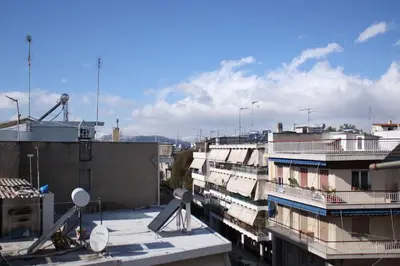 a view of a city with buildings and satellites at Agnes apartment Filopappou in Athens