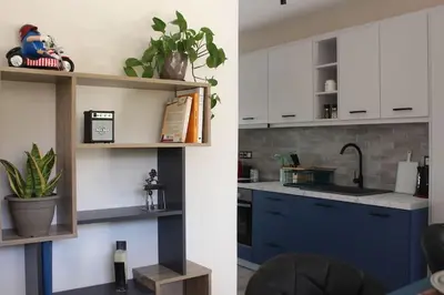 a kitchen with blue cabinets and a sink at Agnes apartment Filopappou in Athens