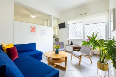a living room with a blue couch and a table at Best spot apartment in Athens in Athens