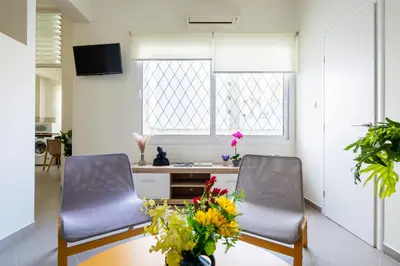two chairs in a room with a desk and flowers at Best spot apartment in Athens in Athens