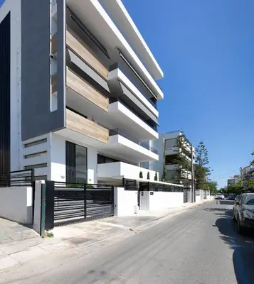 a white building on the side of a street at Athens Riviera Penthouse in Athens
