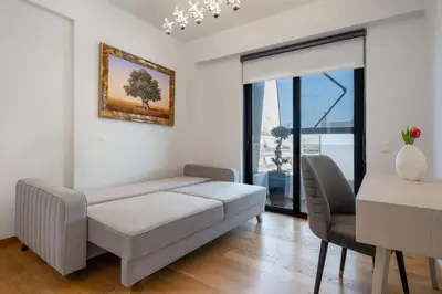 a living room with a couch and a table at Athens Riviera Penthouse in Athens
