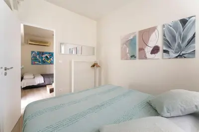 a white bedroom with a bed and a mirror at Minimal luxury 5BDR apt w/terrace AcropolisView in Athens