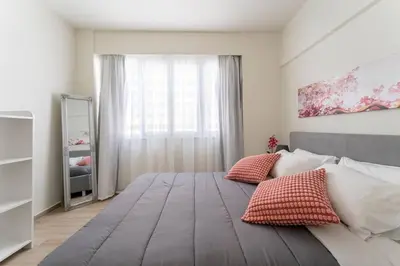 a bedroom with a large bed with two pillows on it at Minimal luxury 5BDR apt w/terrace AcropolisView in Athens