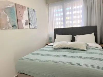 a bed with two pillows on it in a bedroom at Minimal luxury 5BDR apt w/terrace AcropolisView in Athens
