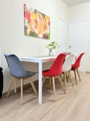 a dining room table with four chairs and a painting at Minimal luxury 5BDR apt w/terrace AcropolisView in Athens