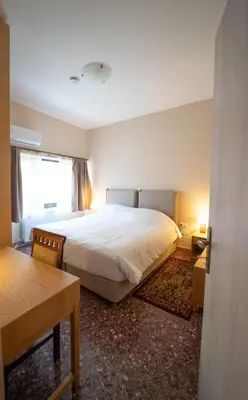 a bedroom with a large white bed and a table at Luxury Apartment in Plaka - Acropolis (Luisa) in Athens