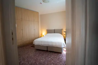 a bedroom with a white bed and cabinets in it at Luxury Apartment in Plaka - Acropolis (Luisa) in Athens