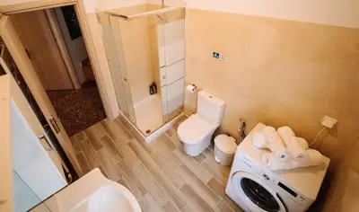 a bathroom with a white toilet and a sink at Luxury Apartment in Plaka - Acropolis (Luisa) in Athens