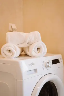 a pile of towels sitting on top of a washing machine at Luxury Apartment in Plaka - Acropolis (Luisa) in Athens