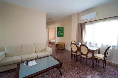 a living room with a couch and a table and chairs at Luxury Apartment in Plaka - Acropolis (Luisa) in Athens