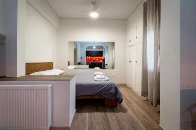 a bedroom with a bed and a television in it at Studio Apartment next to Alsos Ilision in Athens