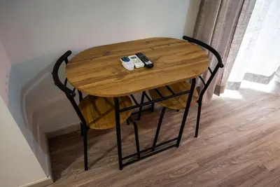 a small wooden table with two remote controls on it at Studio Apartment next to Alsos Ilision in Athens