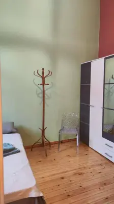 a room with a cross on the wall and a chair at Yellow and blue relax house in Piraeus