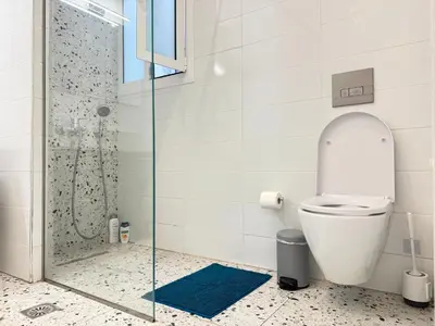 a bathroom with a toilet and a glass shower at P&P Boutique Apartments in Athens