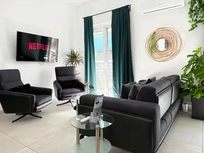 a living room with a couch and two chairs at P&P Boutique Apartments in Athens