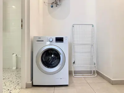 a washer and dryer in a white laundry room at P&P Boutique Apartments in Athens