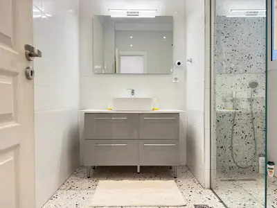 a bathroom with a sink and a shower at P&P Boutique Apartments in Athens