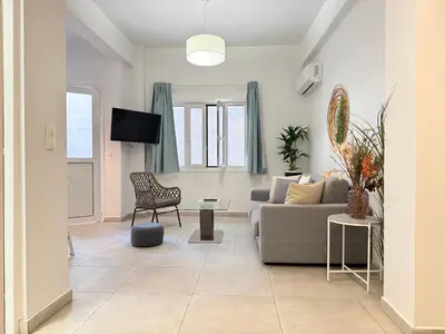 a living room with a couch and a chair at P&P Boutique Apartments in Athens