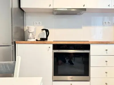 a kitchen with white cabinets and an oven at P&P Boutique Apartments in Athens