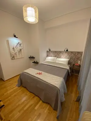 a bedroom with a large bed in a room at Nike’s Katechaki in Athens