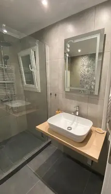 a bathroom with a white sink and a shower at Nike’s Katechaki in Athens
