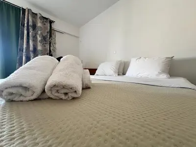 a bedroom with two beds with white sheets and pillows at Athenian Sky View - next to Metro in Athens