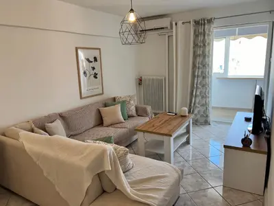 a living room with a couch and a table at Athenian Sky View - next to Metro in Athens