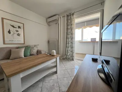a living room with a couch and a table at Athenian Sky View - next to Metro in Athens