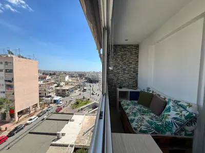 a balcony with a couch and a view of a city at Athenian Sky View - next to Metro in Athens