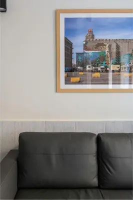 a couch in a room with a picture on the wall at Mooeve Exarchia in Athens