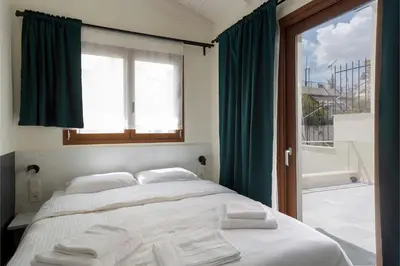 a bedroom with a large bed with a window at Mooeve Exarchia in Athens