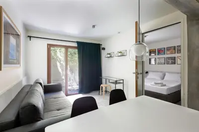 a living room with a couch and a bed at Mooeve Exarchia in Athens