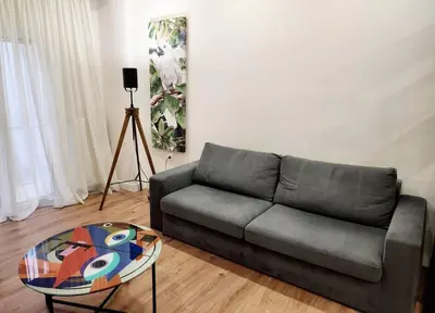 a living room with a couch and a table at Kallithea's Luxury Apartment VIPGreece in Athens