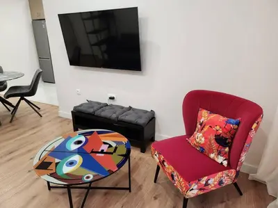 a living room with a couch and a chair and a table at Kallithea's Luxury Apartment VIPGreece in Athens