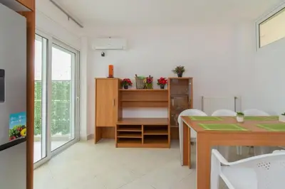 a dining room with a table and a desk at Cozy 2 bedroom apartment in Piraeus in Piraeus