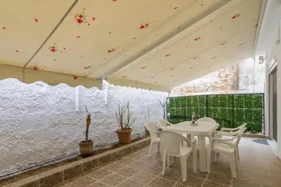 a dining room with a white table and chairs at Cozy 2 bedroom apartment in Piraeus in Piraeus