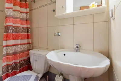 a bathroom with a sink and a toilet at Cozy 2 bedroom apartment in Piraeus in Piraeus