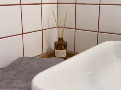 a jar with sticks in it next to a toilet at Nueva era @ Athens heart , Romvis apartments in Athens