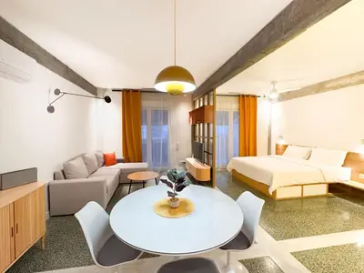 a bedroom with a bed and a white table and chairs at Nueva era @ Athens heart , Romvis apartments in Athens