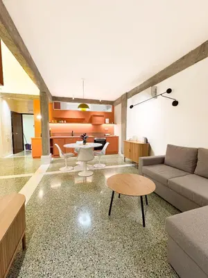 a living room with a couch and a table at Nueva era @ Athens heart , Romvis apartments in Athens
