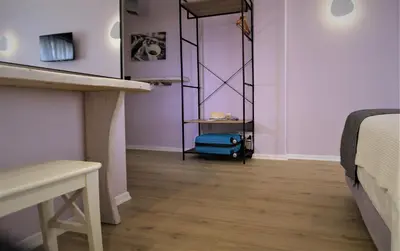 a room with a bed and a blue suitcase at Aiolos Apartments Ermou 64 Monastiraki Plaka Junior Suite in Athens