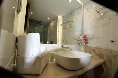 a bathroom with a white bowl sink and a mirror at Aiolos Apartments Ermou 64 Monastiraki Plaka Junior Suite in Athens