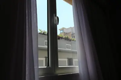 a window with a view of a building at Aiolos Apartments Ermou 64 Monastiraki Plaka Junior Suite in Athens